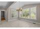 Bright dining area with large windows, neutral walls, and a chandelier at 3600 Trail 23 St, Durham, NC 27707