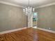 Dining room with hardwood floors, chandelier, and doorway to the kitchen at 3600 Trail 23 St, Durham, NC 27707