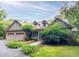 Charming brick home with a three-car garage, well-manicured lawn, and mature trees at 3600 Trail 23 St, Durham, NC 27707