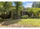 View of the back exterior showing the screened porch, brick facade, and manicured lawn at 3600 Trail 23 St, Durham, NC 27707