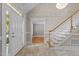 Bright foyer features tile floors, chandelier, staircase, and entry to another room at 3600 Trail 23 St, Durham, NC 27707