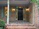 Close up of the front door with sidelights, traditional columns, and slate tile landing at 3600 Trail 23 St, Durham, NC 27707