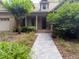 Inviting front entrance with a stone walkway, mature plantings, and a covered porch at 3600 Trail 23 St, Durham, NC 27707