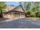 Spacious three-car garage with brick facade and ample driveway parking at 3600 Trail 23 St, Durham, NC 27707