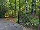Property gate opening to a driveway and lush greenery at 3600 Trail 23 St, Durham, NC 27707