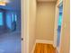 Hallway featuring hardwood floors, views into bedrooms and bathrooms, and neutral paint at 3600 Trail 23 St, Durham, NC 27707