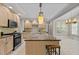 Spacious kitchen with a center island, ample cabinetry, granite countertops, and an adjacent dining area at 3600 Trail 23 St, Durham, NC 27707