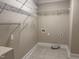 Laundry room with wire shelving, hook ups, and tile flooring at 3600 Trail 23 St, Durham, NC 27707
