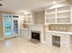Cozy Gathering room featuring a fireplace, built-in shelving, and access to the outdoor space at 3600 Trail 23 St, Durham, NC 27707