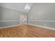 Inviting living room featuring gleaming wood floors, chandelier, and neutral color scheme providing an airy atmosphere at 3600 Trail 23 St, Durham, NC 27707