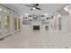 Bright living room with built-in shelving, fireplace, and access to the outdoor living space at 3600 Trail 23 St, Durham, NC 27707