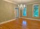 Dining area showcasing hardwood floors, a crystal chandelier, and bright natural light at 3600 Trail 23 St, Durham, NC 27707