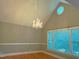 Elegant living room featuring a crystal chandelier, large windows, and hardwood floors at 3600 Trail 23 St, Durham, NC 27707