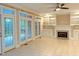 Bright Gathering room featuring a fireplace, built-in shelving, and access to the covered patio at 3600 Trail 23 St, Durham, NC 27707