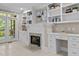 Cozy living room with custom built-ins, fireplace, tiled floors, and French doors to private patio at 3600 Trail 23 St, Durham, NC 27707