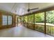 Spacious screened-in porch with wood floors, fan, and a view of the backyard at 3600 Trail 23 St, Durham, NC 27707