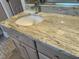 Close-up of a bathroom vanity with a granite countertop and under-cabinet storage at 3600 Trail 23 St, Durham, NC 27707