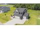 Inviting two-story home with manicured lawn and a double garage, surrounded by lush greenery at 385 Jackson Pond Dr, Smithfield, NC 27577