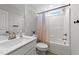 Bathroom featuring a shower/tub combo with a small window and a single sink vanity at 385 Jackson Pond Dr, Smithfield, NC 27577