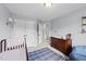 Neutral Bedroom featuring a changing table, crib, and closet with double doors at 385 Jackson Pond Dr, Smithfield, NC 27577