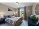 Comfortable bedroom with a bed, a cozy quilt, and a window overlooking the backyard at 385 Jackson Pond Dr, Smithfield, NC 27577