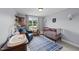 Charming Bedroom with a crib, changing table, rocking chair, and a blue plaid rug at 385 Jackson Pond Dr, Smithfield, NC 27577