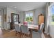 Charming dining room with a wooden table and views of the backyard at 385 Jackson Pond Dr, Smithfield, NC 27577