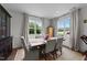 Elegant dining room with large windows, a wood table, and neutral decor at 385 Jackson Pond Dr, Smithfield, NC 27577