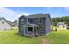 Aerial view of the home's backyard with a covered porch and large lawn at 385 Jackson Pond Dr, Smithfield, NC 27577