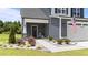 Close up of a charming front porch, decorative plants, and a short walkway to the home at 385 Jackson Pond Dr, Smithfield, NC 27577