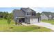 Inviting front porch with decorative plants and charming seating area leading to the main entrance at 385 Jackson Pond Dr, Smithfield, NC 27577