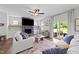Bright living room with sliding glass doors to the backyard and a stone fireplace at 385 Jackson Pond Dr, Smithfield, NC 27577