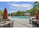 Community pool with lounge chairs and umbrellas, surrounded by trees and greenery at 400 Indian Elm Ln, Cary, NC 27519