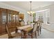 Elegant dining room showcases a wooden table with six chairs, a classic china cabinet, and a bright bay window at 400 Indian Elm Ln, Cary, NC 27519