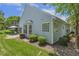 Home featuring a backyard patio, a well-maintained lawn, and mature trees at 400 Indian Elm Ln, Cary, NC 27519