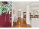 Inviting home foyer with hardwood floors, an entry bench, and views into the dining room with classic furnishings at 400 Indian Elm Ln, Cary, NC 27519