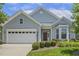 Charming single-story home features a manicured lawn, two-car garage, and a welcoming red front door with a wreath at 400 Indian Elm Ln, Cary, NC 27519