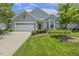 Well-maintained single-story house with a tidy front lawn, bay window, and two-car garage showcasing curb appeal at 400 Indian Elm Ln, Cary, NC 27519