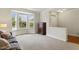 Spacious living room has a bay window, neutral carpet, and a traditional cabinet, perfect for relaxing and entertaining at 400 Indian Elm Ln, Cary, NC 27519