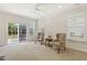 Bright living room with neutral carpet, chairs, and sliding door to the patio at 400 Indian Elm Ln, Cary, NC 27519