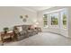 Bright living room features a comfortable floral sofa, accent tables, and a large bay window offering natural light at 400 Indian Elm Ln, Cary, NC 27519