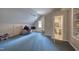 Finished attic space featuring a sloped ceiling, plush chair, and a small bathroom off to the side at 405 Widdington Ln, Cary, NC 27519