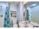 Well-lit bathroom with a shower, toilet, sink, and a decorative built-in shelf, all in a clean, modern style at 405 Widdington Ln, Cary, NC 27519
