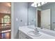 Bathroom features a white vanity, decorative mirror, and doorway view of a staircase landing at 405 Widdington Ln, Cary, NC 27519
