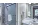 Bathroom features a frosted glass shower, white sink, and vanity with a large mirror at 405 Widdington Ln, Cary, NC 27519