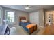 Cozy bedroom with neutral walls, a wooden bed near a window, and a double door closet at 405 Widdington Ln, Cary, NC 27519