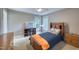 Neutral bedroom with a ceiling fan, wooden bed, a window view, and natural light at 405 Widdington Ln, Cary, NC 27519