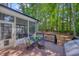 Outdoor deck with a table and chairs, perfect for enjoying the serene backyard and mature trees at 405 Widdington Ln, Cary, NC 27519