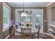 Cozy dining area with a round table, chairs, a bird cage, and views of the backyard through the windows at 405 Widdington Ln, Cary, NC 27519