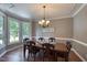 Traditional dining room with a wood table, chandelier, and bay window at 405 Widdington Ln, Cary, NC 27519